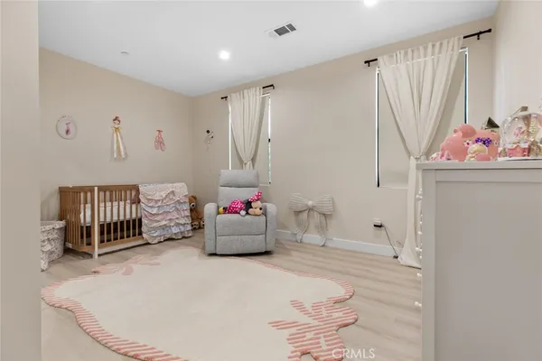 a bedroom with a bed next to a window