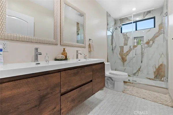 a bathroom with a sink a mirror and a shower