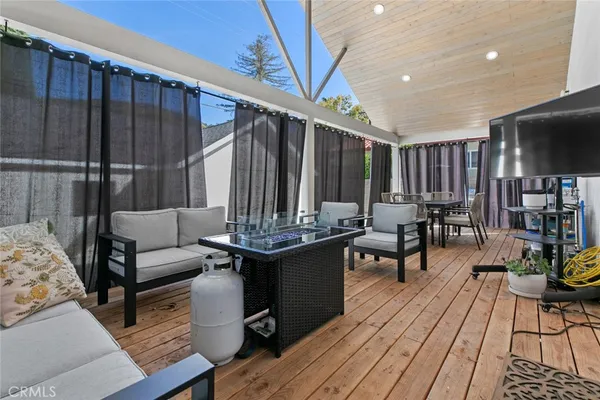 a view of a refrigerator in kitchen and an empty room