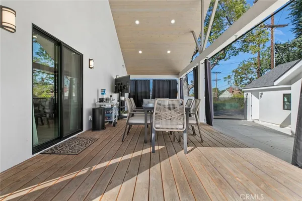a view of a house with a big yard plants and large trees