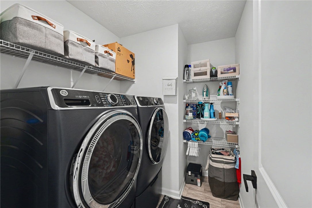 3011 Falls Road Clayton, OH 45315 - Photo 52 of 66 Functional laundry room equipped with modern appliances and ample shelving for storage convenience.