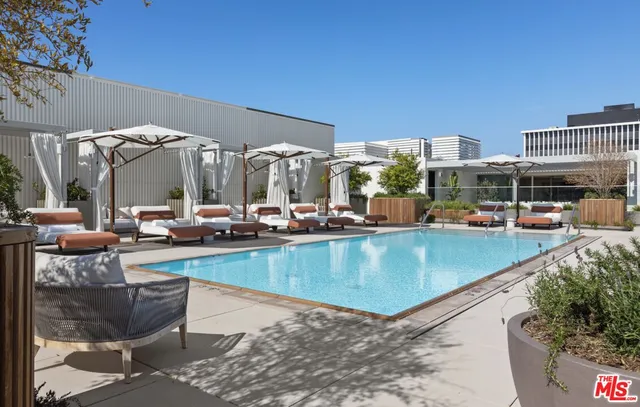 a view of a swimming pool with outdoor seating