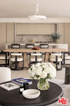 a kitchen with a dining table and chairs
