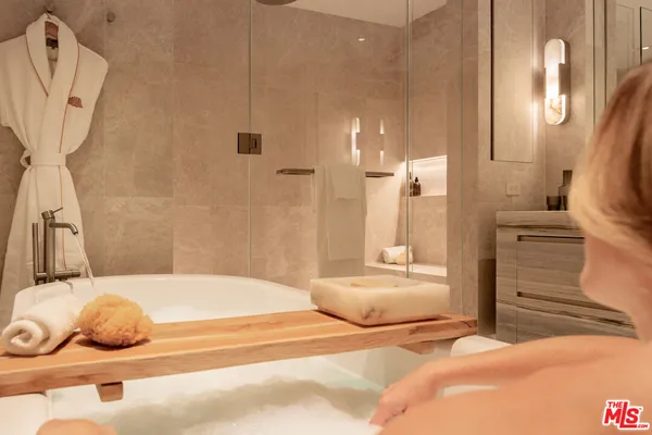 a bedroom with a bed and a mirror
