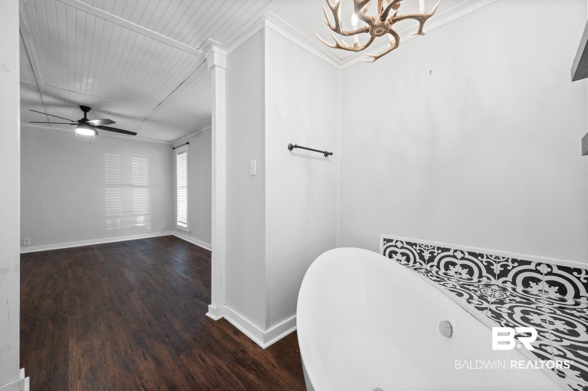 503 North Holly Street Foley, AL 36535 - Photo 15 of 23 Bathroom with a bath, crown molding, ceiling fan with notable chandelier, and hardwood / wood-style floors