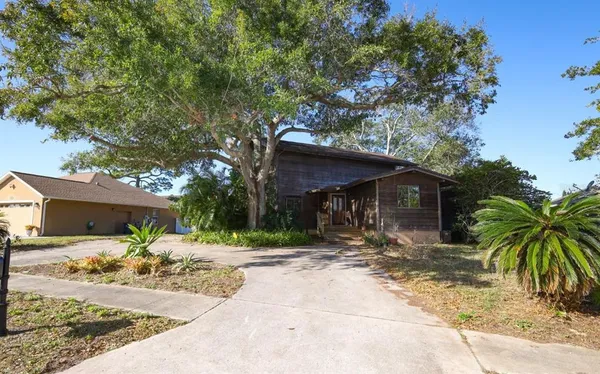 a view of a house with a tree in front