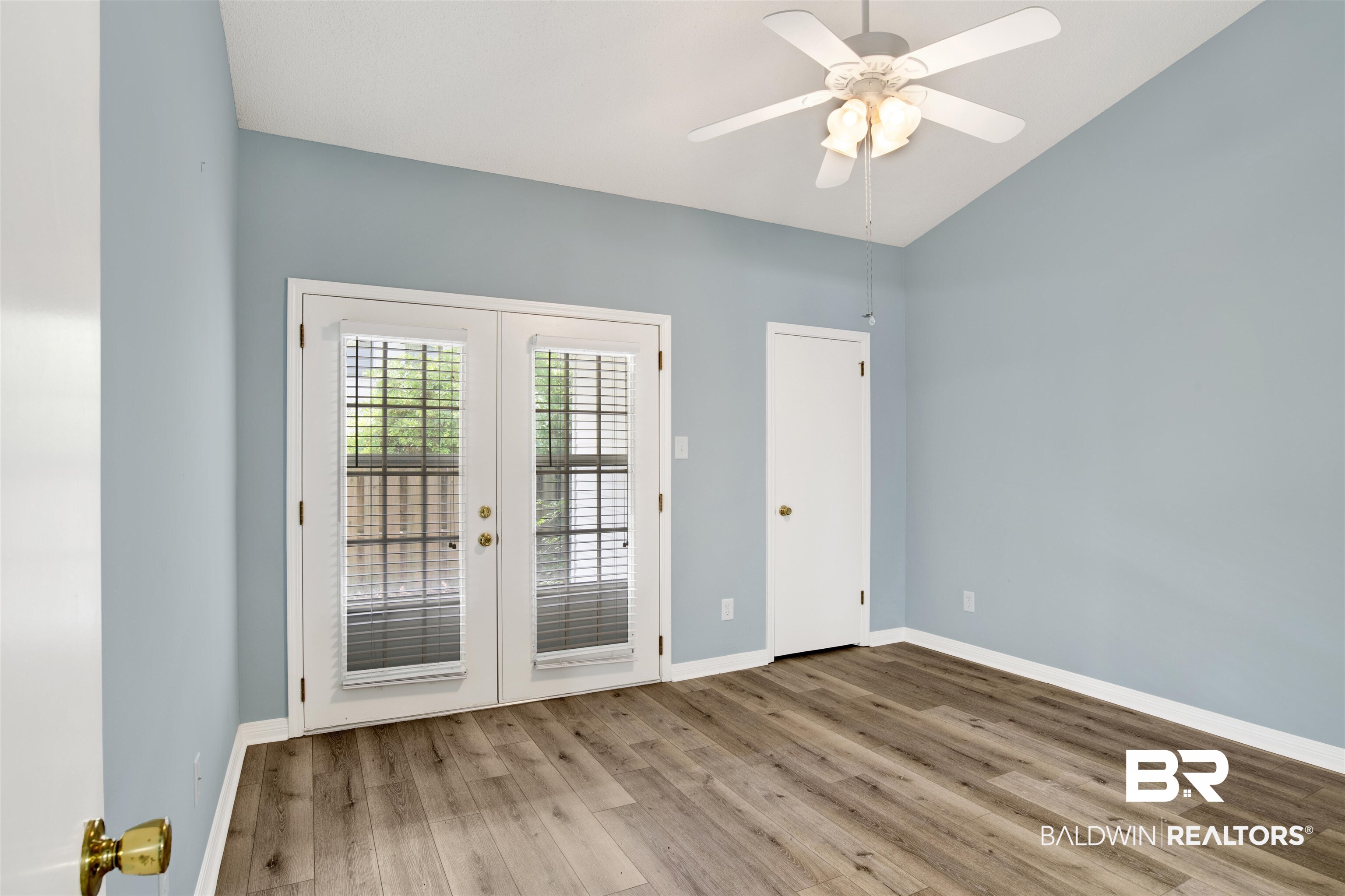 1258 Sutton Court, Unit 4 Mobile, AL 36609 - Photo 15 of 19 Doorway with french doors, a ceiling fan, baseboards, wood finished floors, and lofted ceiling