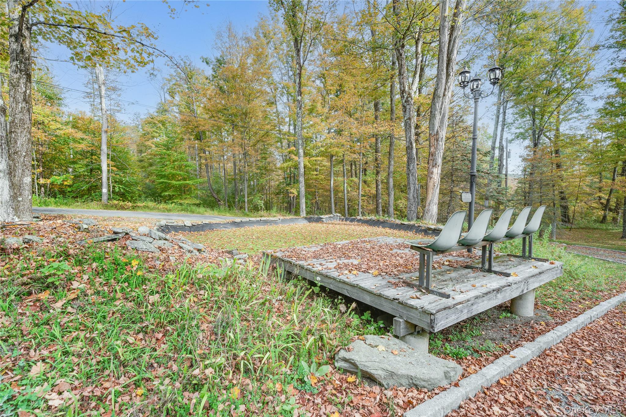 91 Decker Road Ancram, NY 12502 - Photo 30 of 35 a view of a bench in a backyard with large tree