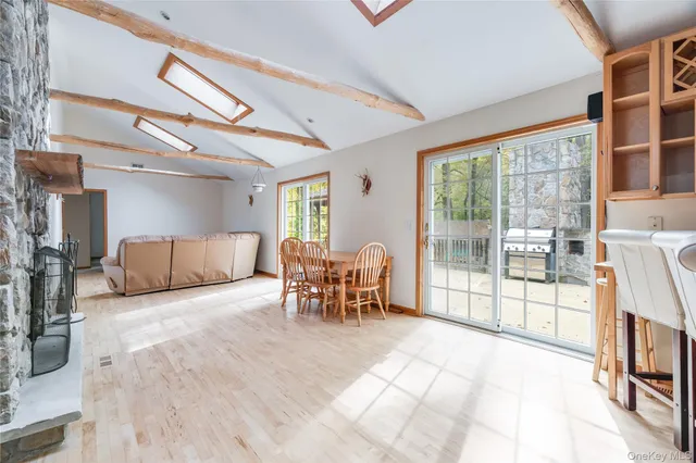 a view of a livingroom with furniture and floor to ceiling window