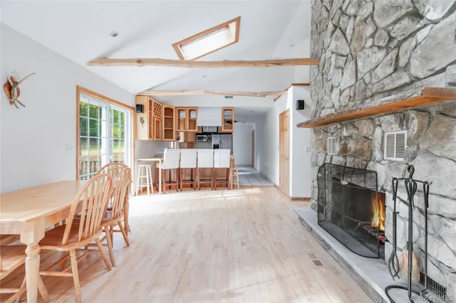 a dining room with furniture and wooden floor