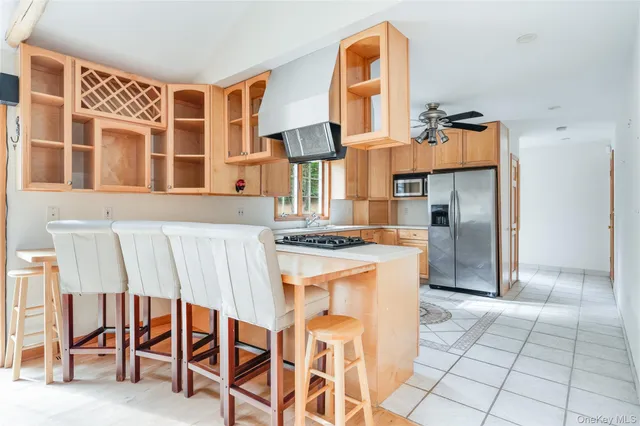 a kitchen with stainless steel appliances granite countertop a stove and a refrigerator