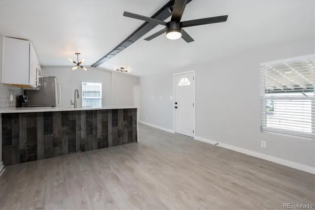 en empty room with wooden floor and window