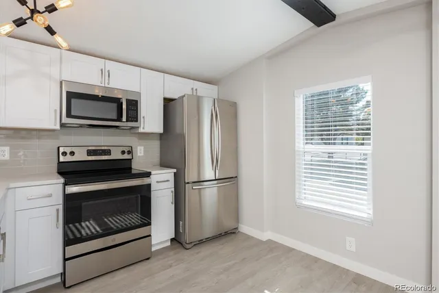 a kitchen with stainless steel appliances a stove a microwave and a refrigerator