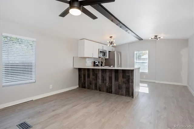 a kitchen with stainless steel appliances kitchen island a wooden floor