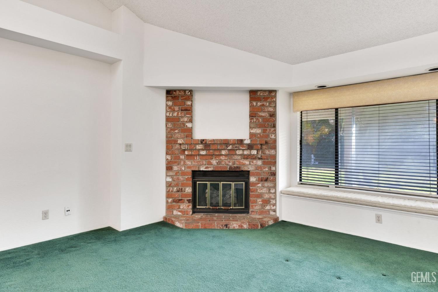 Undisclosed Address Bakersfield, CA 93311 - Photo 11 of 44 a living room with fireplace and a fireplace