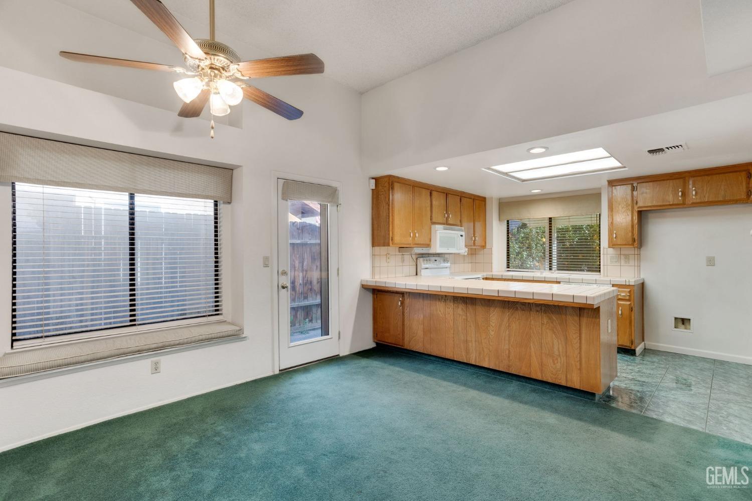 Undisclosed Address Bakersfield, CA 93311 - Photo 13 of 44 a kitchen with a stove a sink and a refrigerator