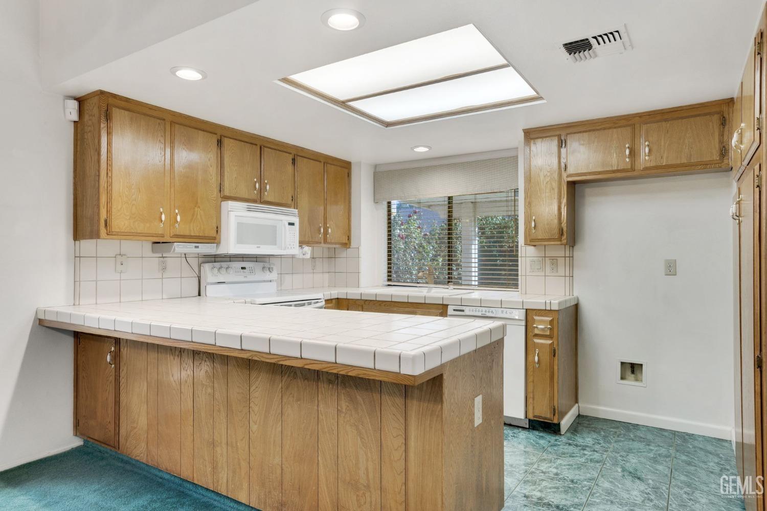 Undisclosed Address Bakersfield, CA 93311 - Photo 14 of 44 a kitchen with a sink stove and cabinets