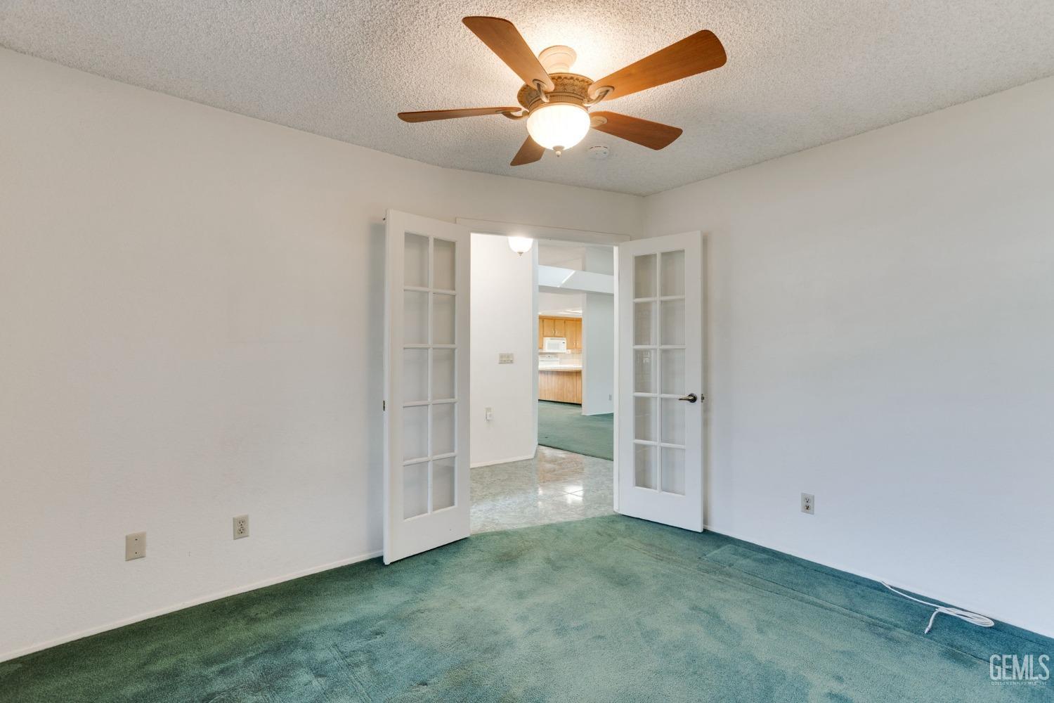 Undisclosed Address Bakersfield, CA 93311 - Photo 21 of 44 an empty room with a ceiling fan and a window