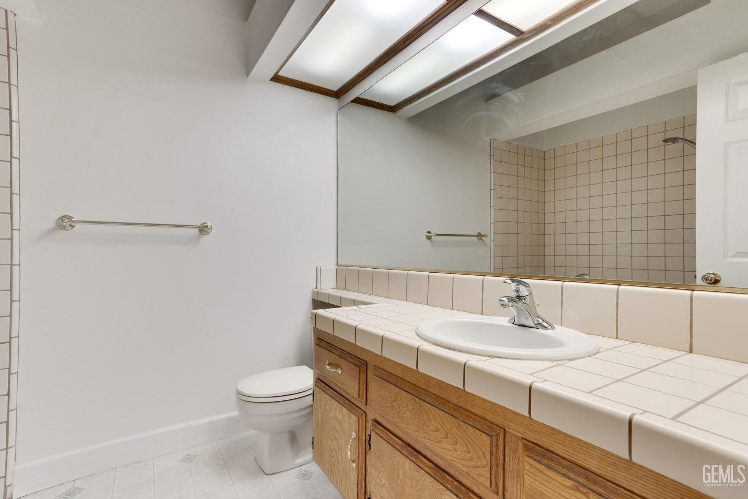 Undisclosed Address Bakersfield, CA 93311 - Photo 22 of 44 a bathroom with a sink a toilet and shower