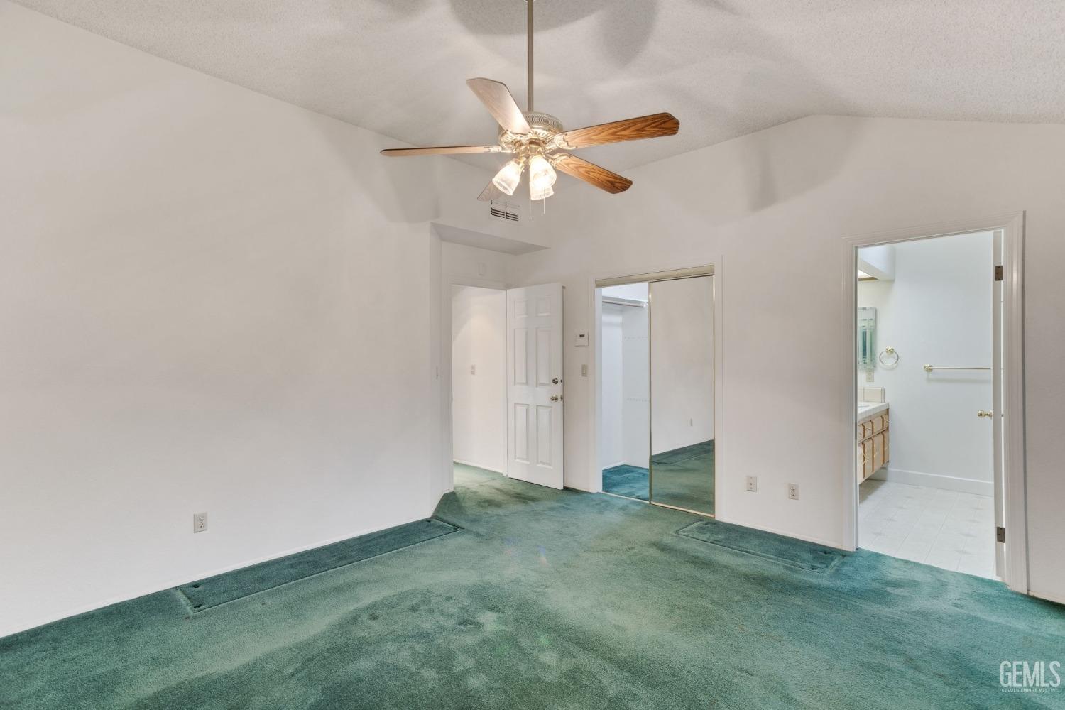 Undisclosed Address Bakersfield, CA 93311 - Photo 25 of 44 an empty room with closet and a chandelier fan