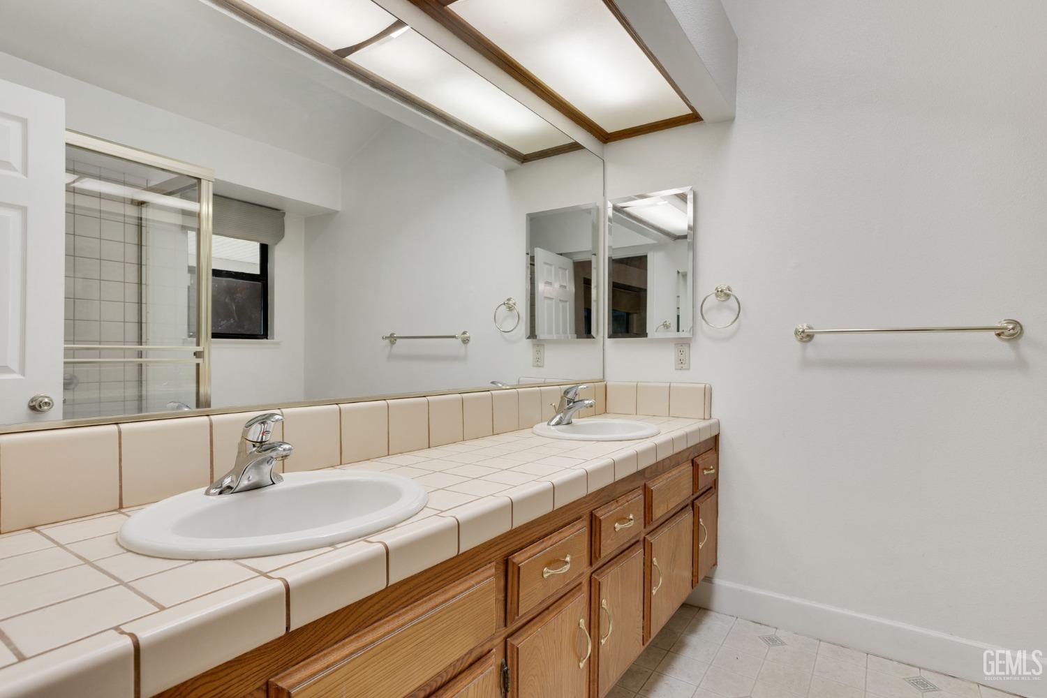 Undisclosed Address Bakersfield, CA 93311 - Photo 28 of 44 a bathroom with a sink and a mirror
