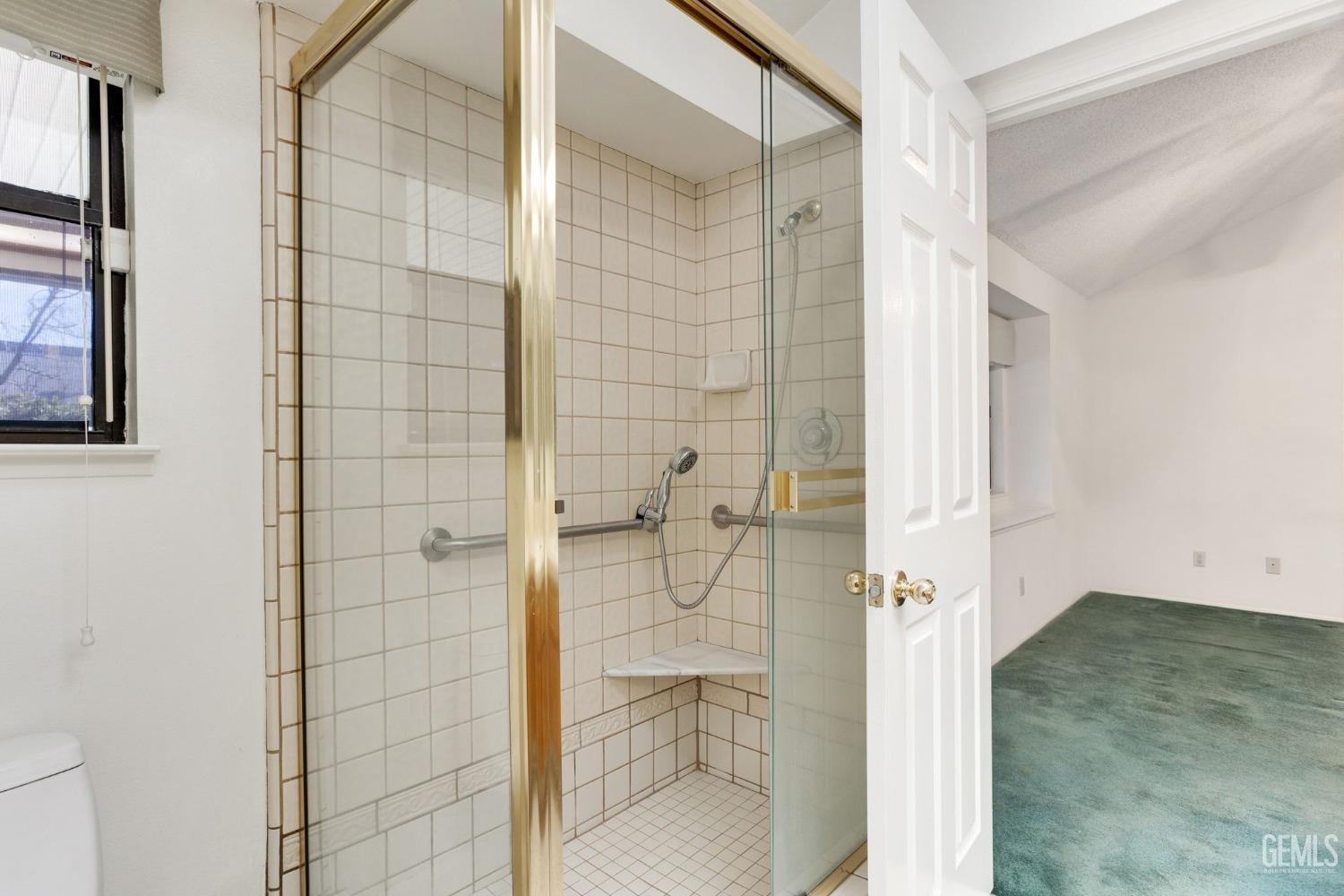 Undisclosed Address Bakersfield, CA 93311 - Photo 29 of 44 a bathroom with a glass shower door