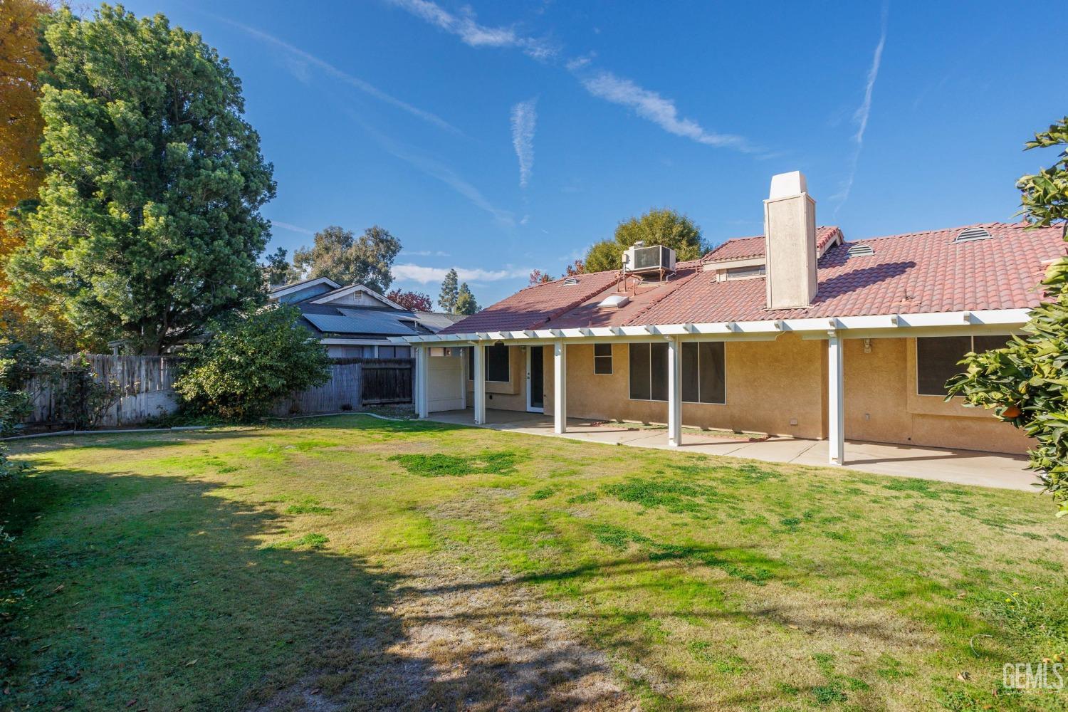 Undisclosed Address Bakersfield, CA 93311 - Photo 37 of 44 a front view of a house with a garden