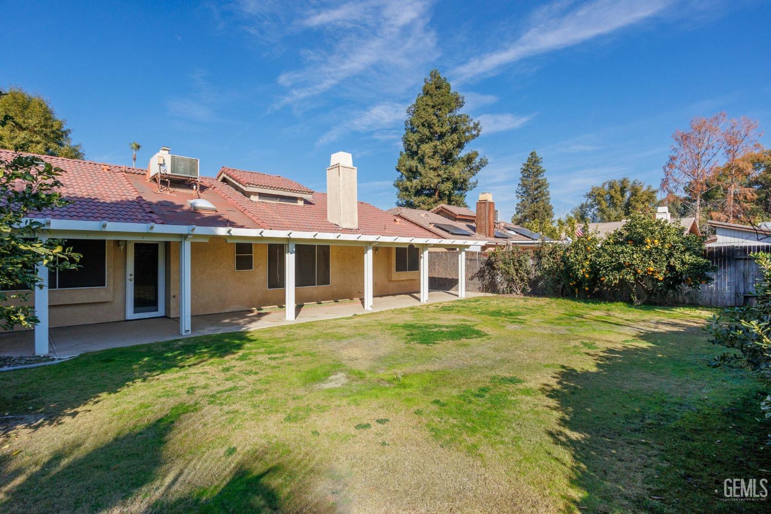 Undisclosed Address Bakersfield, CA 93311 - Photo 38 of 44 a front view of a house with a garden