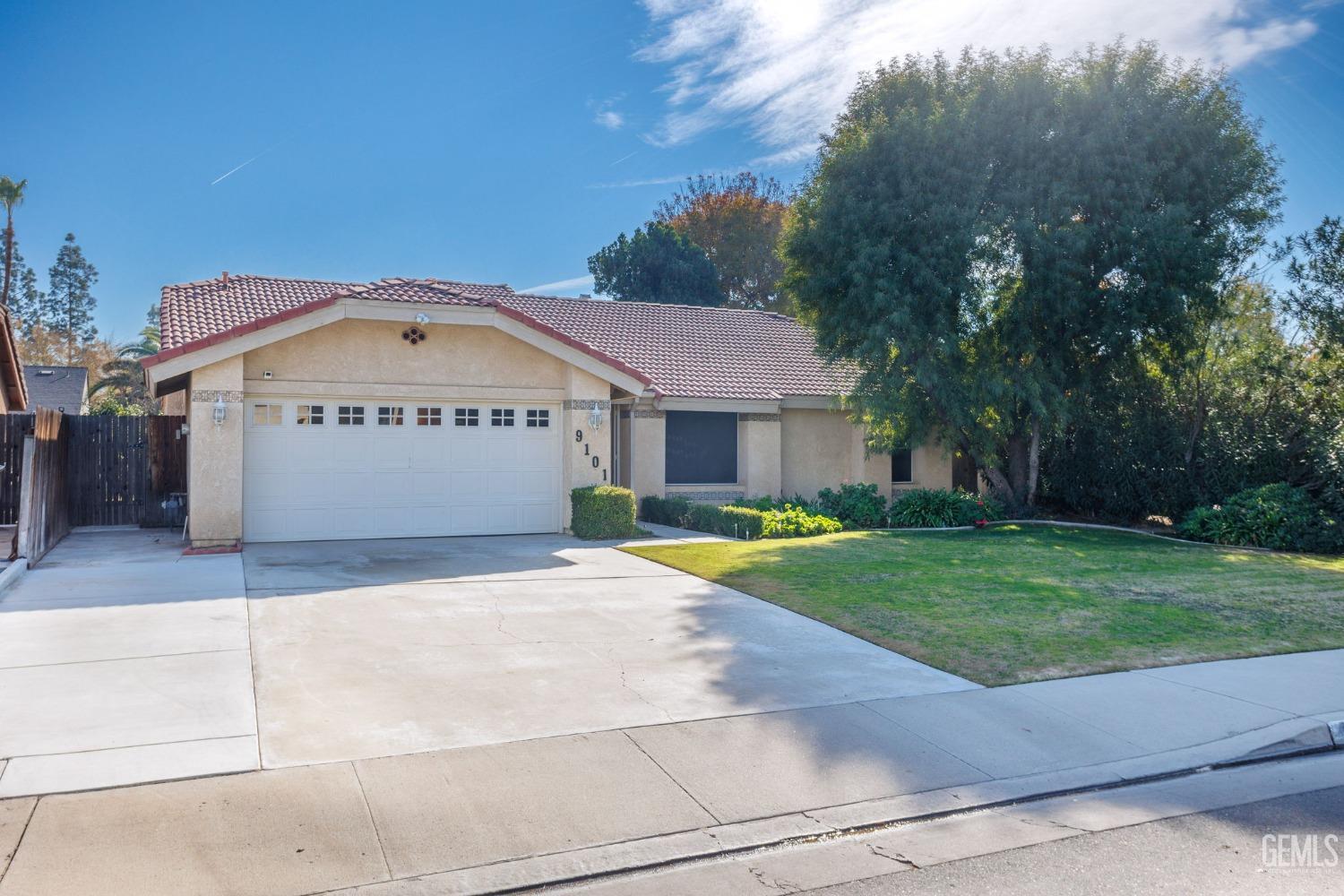 Undisclosed Address Bakersfield, CA 93311 - Photo 44 of 44 a front view of a house with a yard and garage