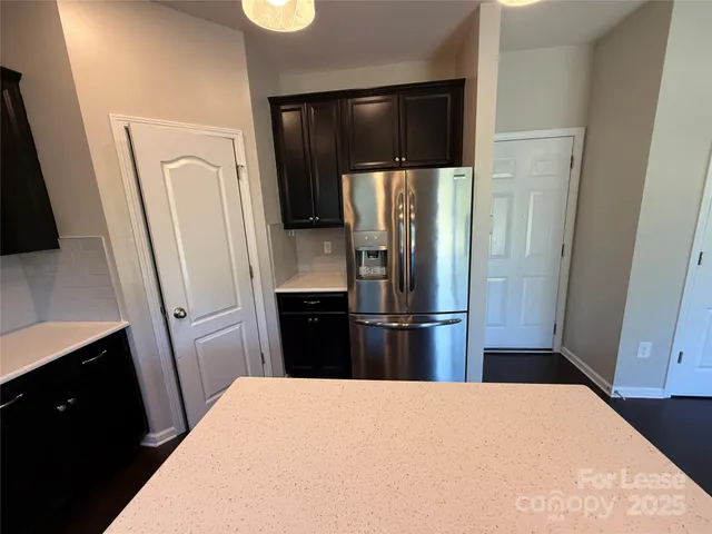 a kitchen with stainless steel appliances a refrigerator and a sink