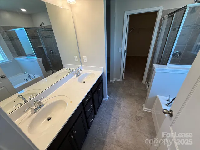 a bathroom with a double vanity sink and a mirror
