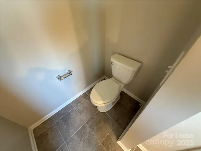 a white toilet sitting in a bathroom