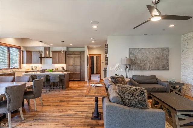 a living room with lots of furniture and kitchen view