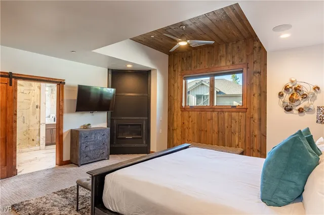 a bedroom with a bed and a television