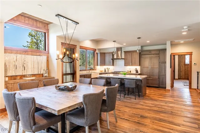 a dining room with stainless steel appliances kitchen island a table and chairs