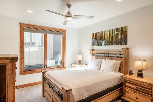 a bedroom with a large bed and a chandelier