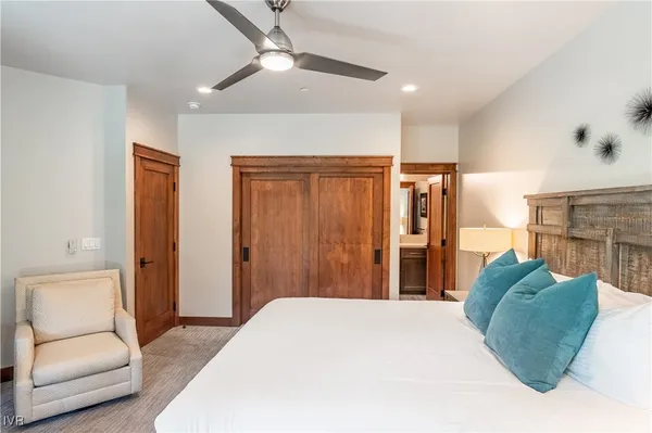 a bedroom with a bed and a chair