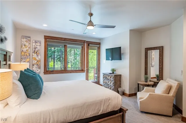 a bedroom with a large bed and a large window