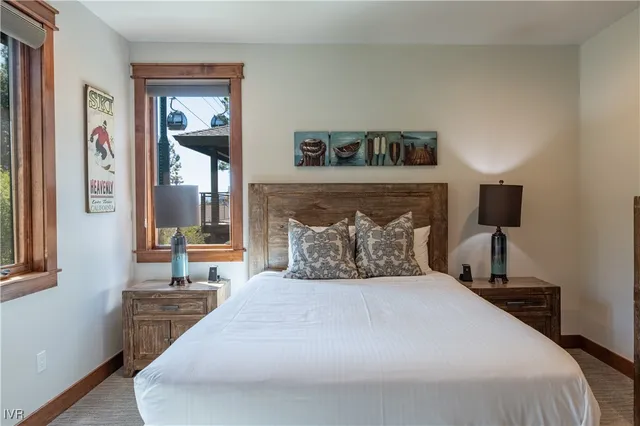 a bedroom with a large bed and a window