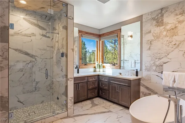 a bathroom with a double vanity sink toilet and shower