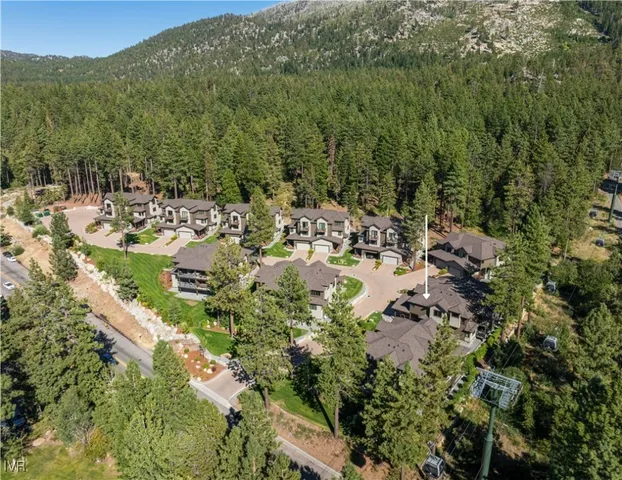 a view of a house with a yard and mountains