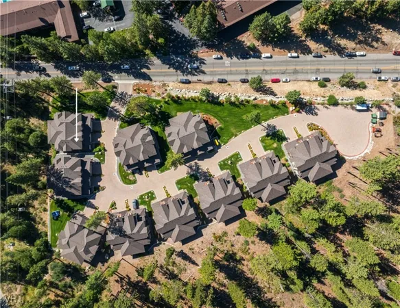 an aerial view of residential houses with outdoor space