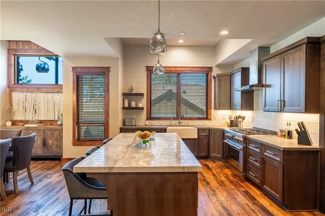 a kitchen with a sink stove and wooden cabinets