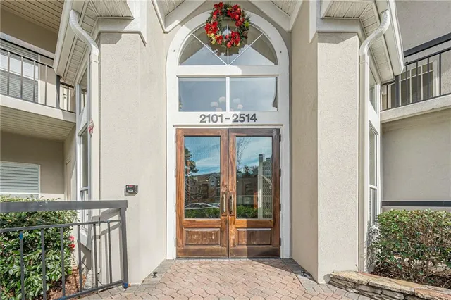 a kitchen with stainless steel appliances granite countertop a refrigerator a stove a sink dishwasher and white countertops with wooden floor