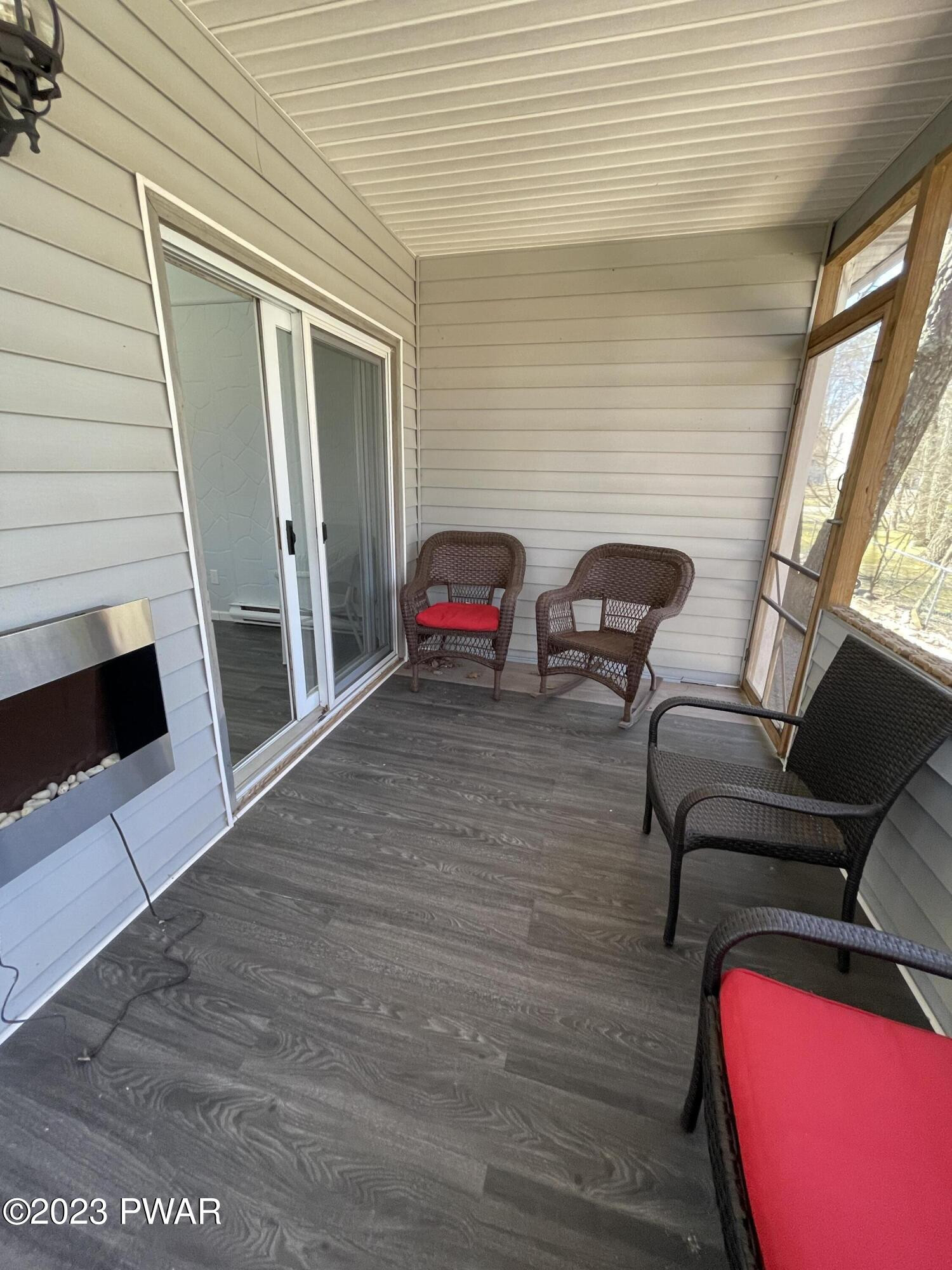 146 Roundhill Road Dingmans Ferry, PA 18328 - Photo 42 of 53 a view of a balcony with chair and front door