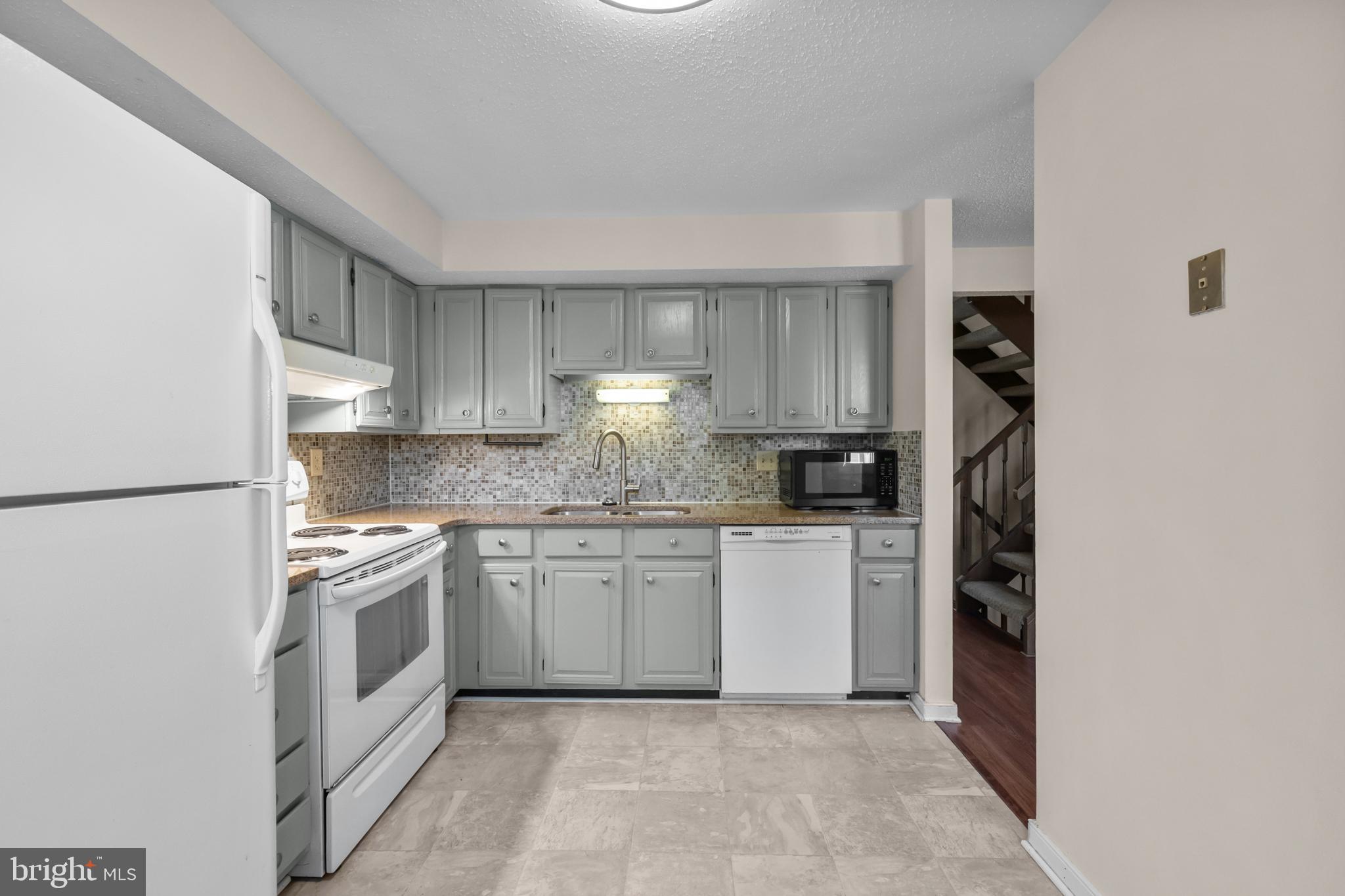 6832 Heatherway Court Alexandria, VA 22315 - Photo 11 of 37 a kitchen with stainless steel appliances granite countertop a refrigerator sink and stove
