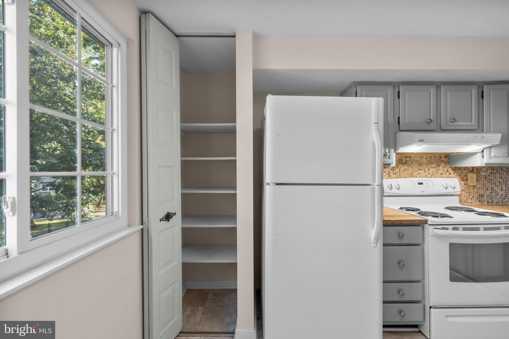 6832 Heatherway Court Alexandria, VA 22315 - Photo 14 of 37 a white refrigerator freezer and a stove sitting inside of a kitchen