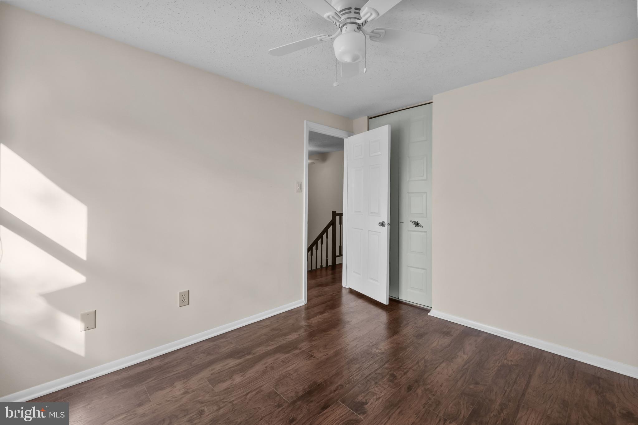 6832 Heatherway Court Alexandria, VA 22315 - Photo 18 of 37 a view of an empty room with wooden floor and a window
