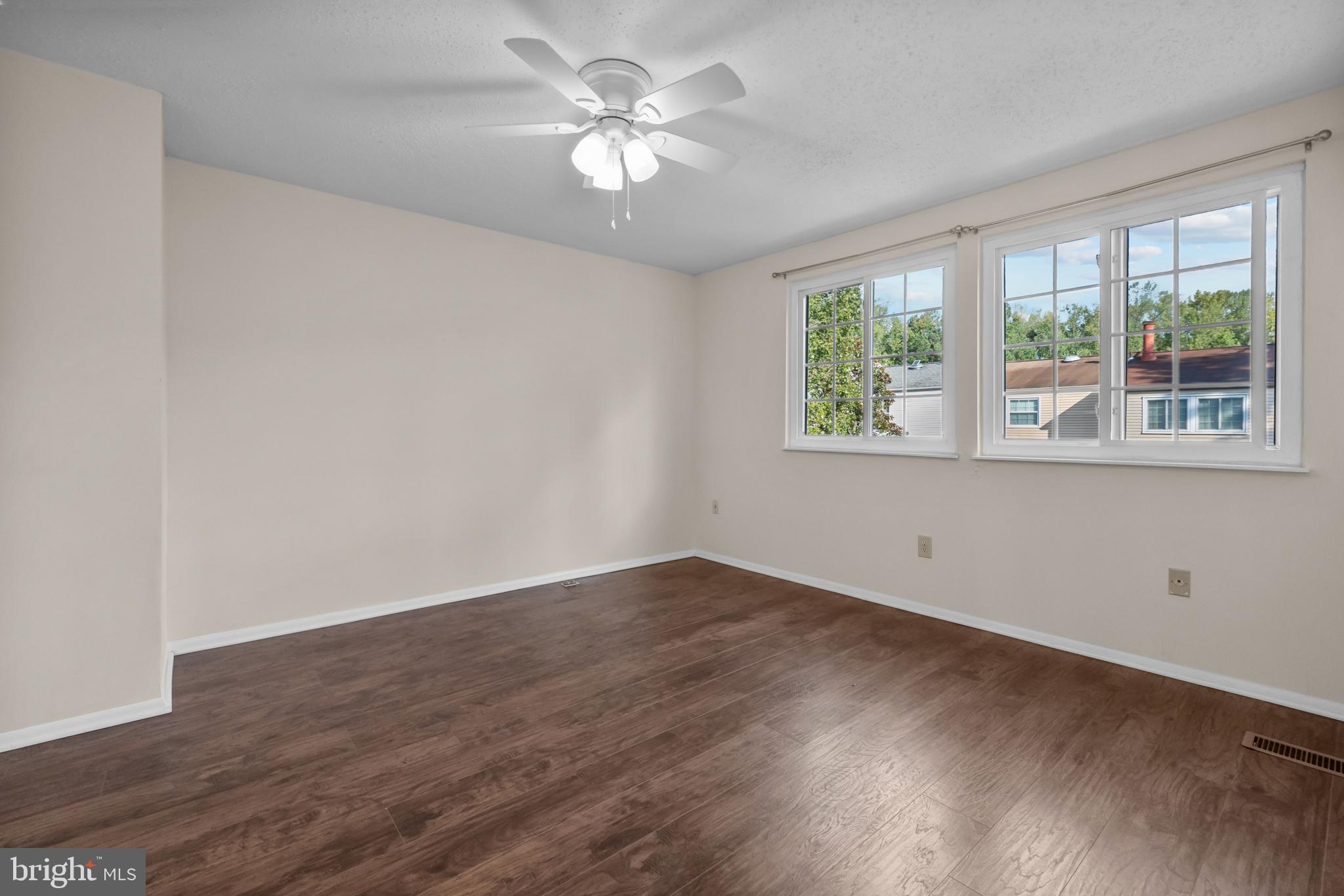 6832 Heatherway Court Alexandria, VA 22315 - Photo 19 of 37 wooden floor in an empty room with a window