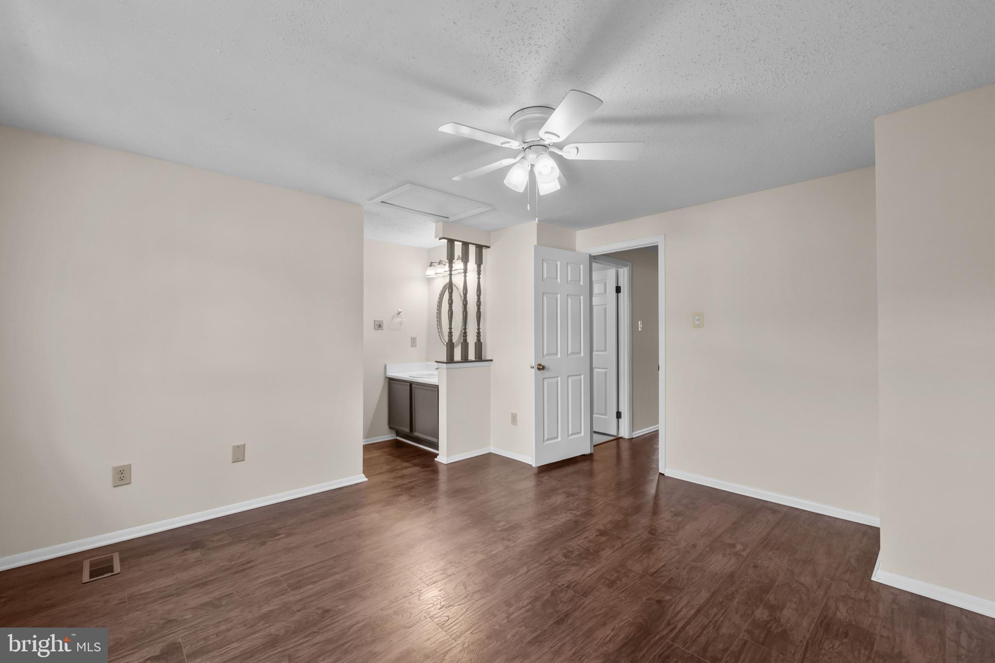 6832 Heatherway Court Alexandria, VA 22315 - Photo 20 of 37 an empty room with wooden floor and windows